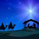 Representation of Christmas Nativity scene. Holy Family figurines are under a hut and three Wise Men on camels figurines coming in the desert, in silhouette style. In the background, blue starly sky and intense rays of light coming from the Comet Star. XXXL concept image image.